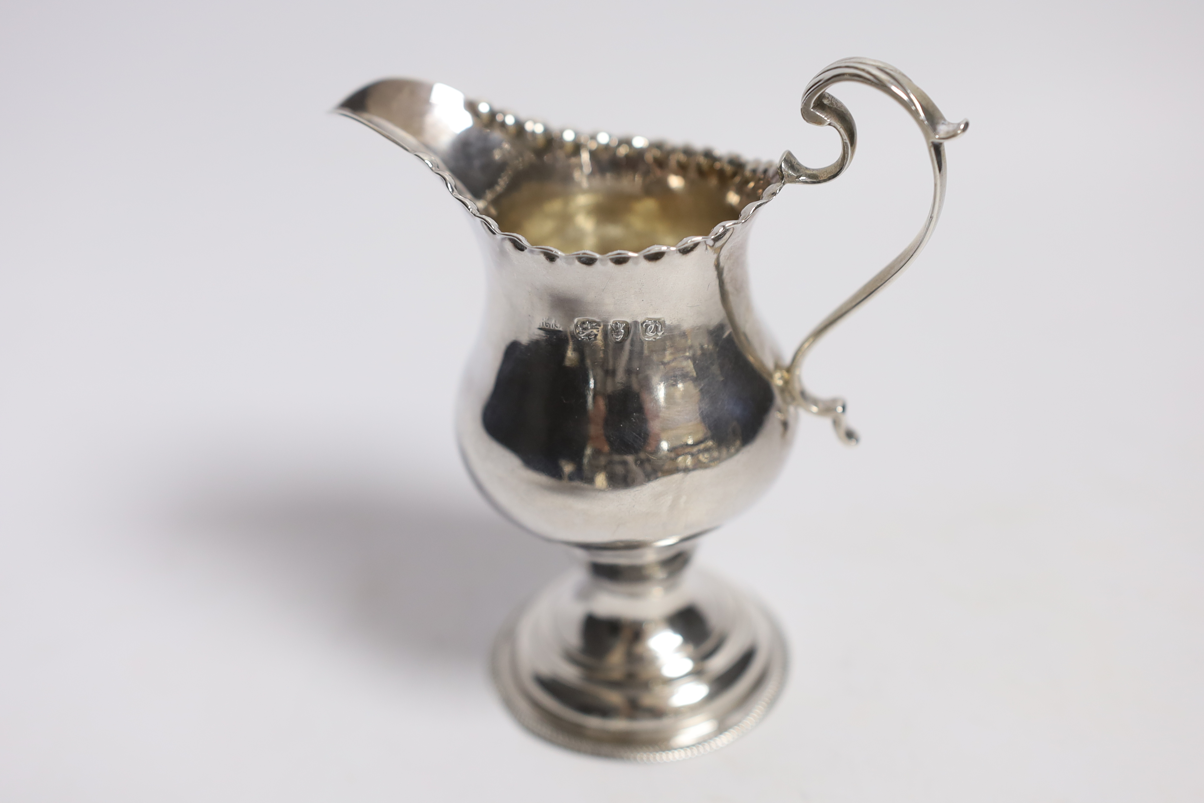 A George III silver inverted pear shaped cream jug, by Hester Bateman, London, 1775, 11.3cm.